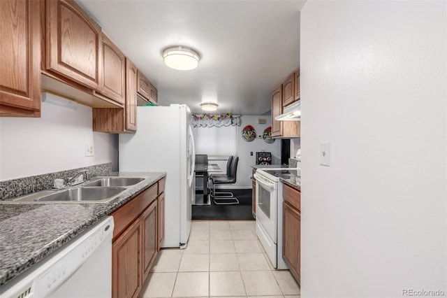 kitchen featuring light tile patterned floors, white appliances, and sink