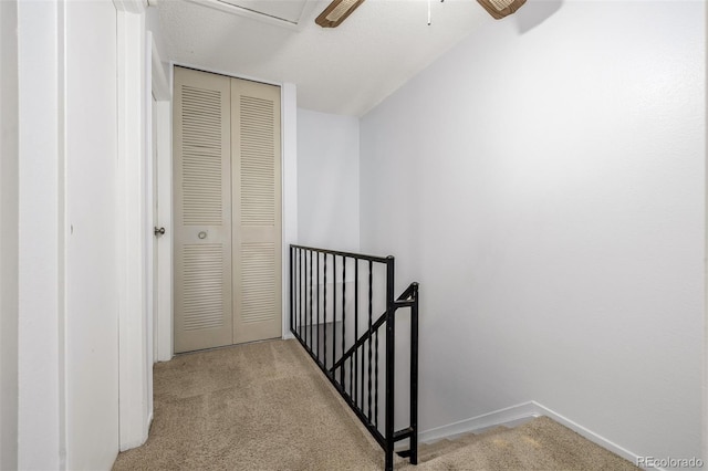 corridor featuring light colored carpet