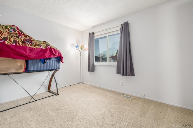 unfurnished bedroom with carpet floors and a textured ceiling