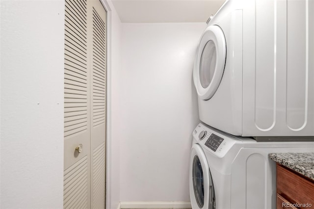 clothes washing area with stacked washer / drying machine