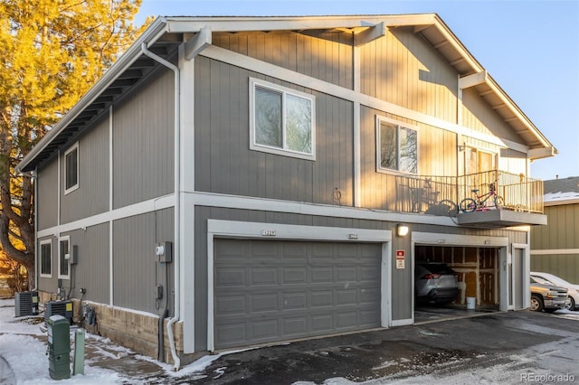 view of property exterior with central AC and a garage