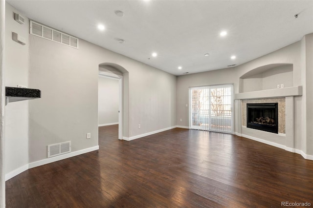 unfurnished living room featuring dark wood-type flooring