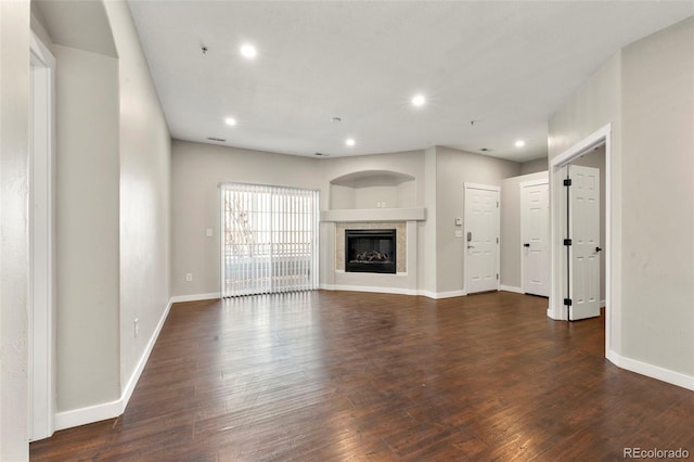 unfurnished living room featuring dark wood-type flooring