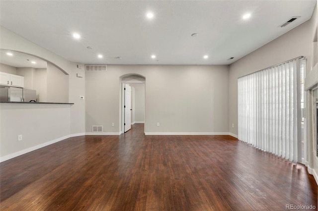 unfurnished living room featuring dark hardwood / wood-style flooring