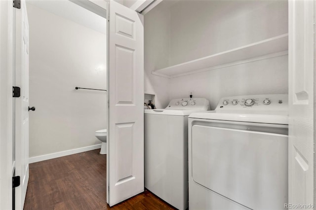 clothes washing area featuring washer and dryer and dark hardwood / wood-style floors