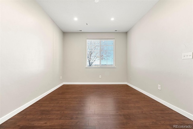 spare room featuring dark wood-type flooring