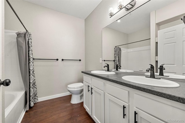 full bathroom with wood-type flooring, toilet, vanity, and shower / bath combo