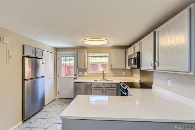 5828 S Pearl St, Centennial, CO 80121 - kitchen featuring appliances with stainless steel finishes, gray cabinets, a peninsula, and light tile patterned floors