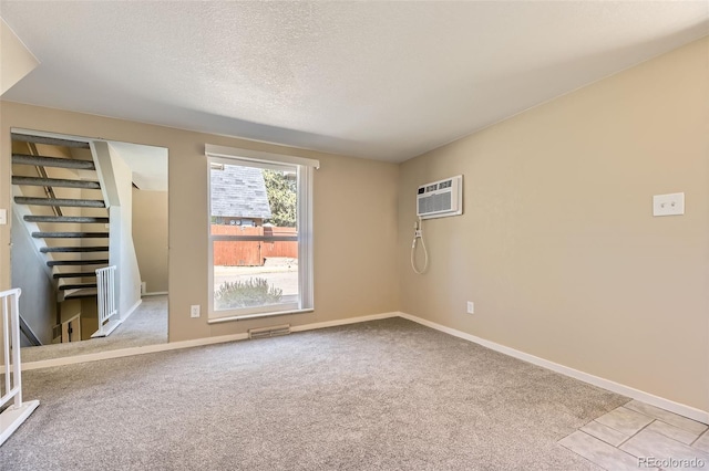 5828 S Pearl St, Centennial, CO 80121 - carpeted empty room with stairs, a textured ceiling, and an AC wall unit