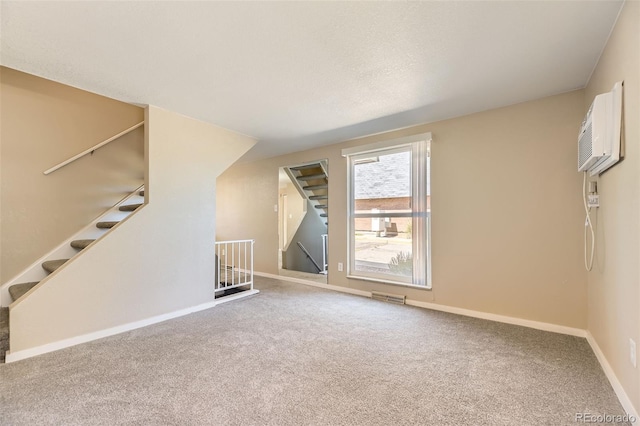 5828 S Pearl St, Centennial, CO 80121 - unfurnished living room with carpet flooring, stairs, and a wall unit AC