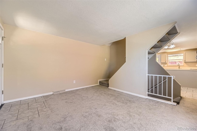 5828 S Pearl St, Centennial, CO 80121 - basement featuring stairs, a textured ceiling, and carpet