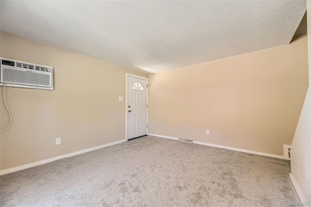 5828 S Pearl St, Centennial, CO 80121 - spare room with carpet floors, an AC wall unit, and a textured ceiling