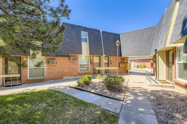 5828 S Pearl St, Centennial, CO 80121 - back of property featuring a shingled roof, mansard roof, and brick siding