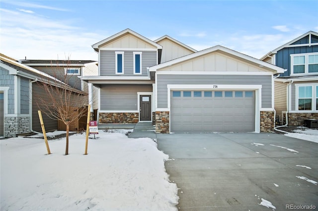 craftsman inspired home featuring stone siding, board and batten siding, concrete driveway, and an attached garage