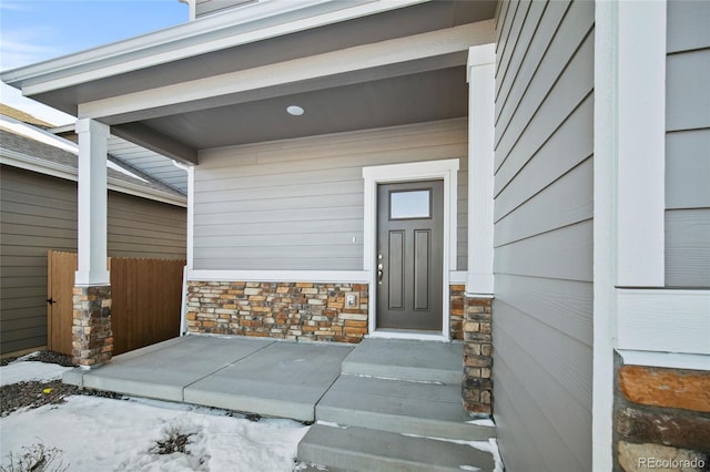 property entrance featuring stone siding