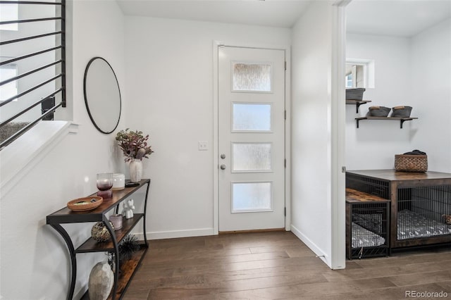 foyer featuring wood finished floors and baseboards