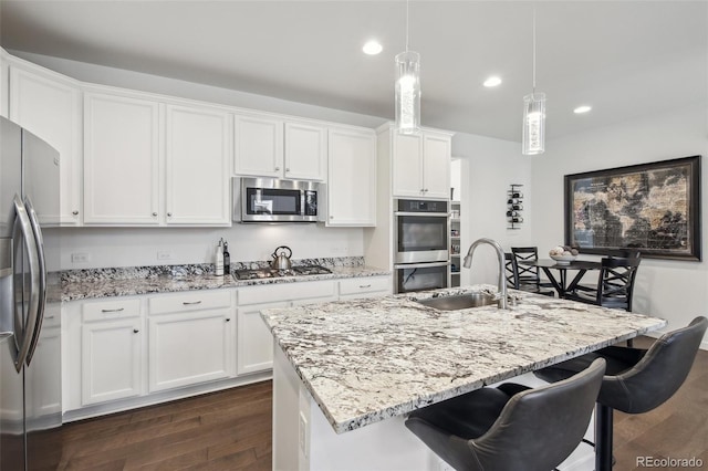 kitchen featuring a sink, white cabinets, dark wood-style floors, and stainless steel appliances