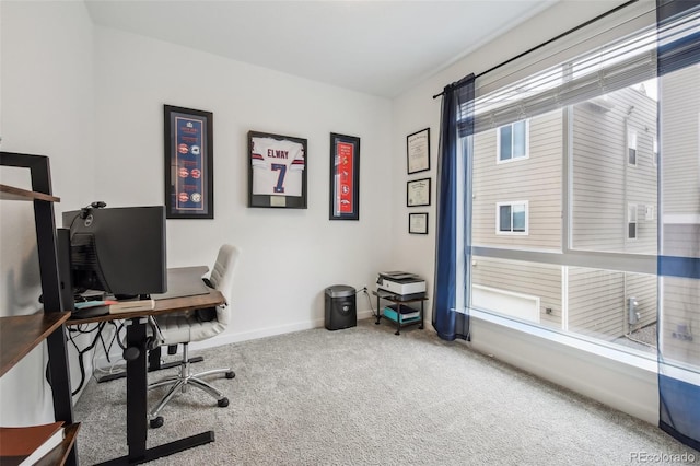 carpeted office featuring baseboards