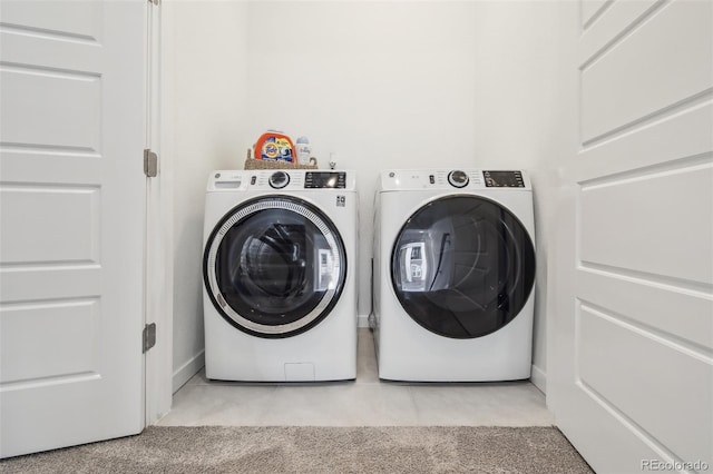 laundry area featuring light tile patterned flooring, laundry area, light colored carpet, and separate washer and dryer