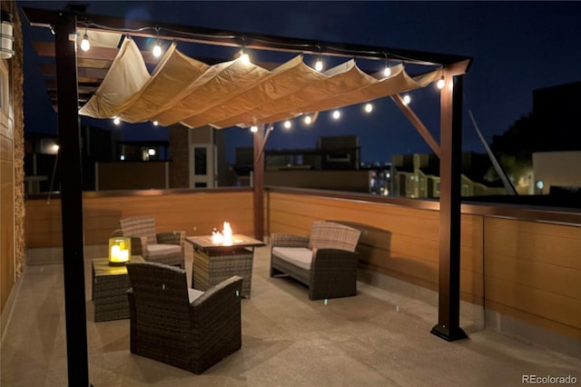 patio at twilight with an outdoor living space with a fire pit and a pergola