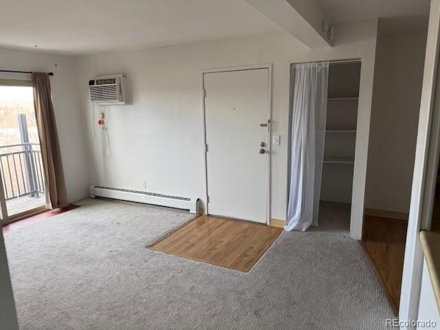 interior space featuring baseboard heating and a wall mounted AC