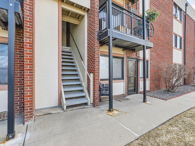 property entrance featuring brick siding