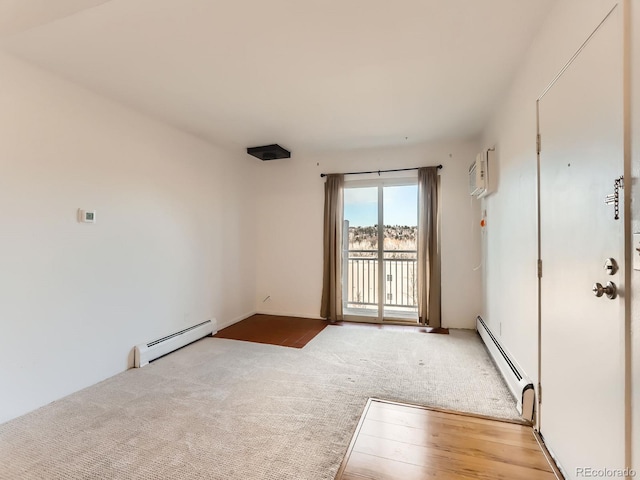 carpeted empty room featuring a wall mounted AC, wood finished floors, and a baseboard radiator