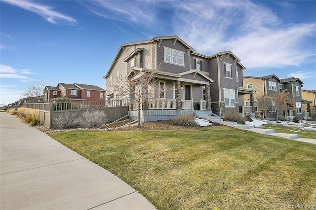 view of front of home featuring covered porch and a front yard