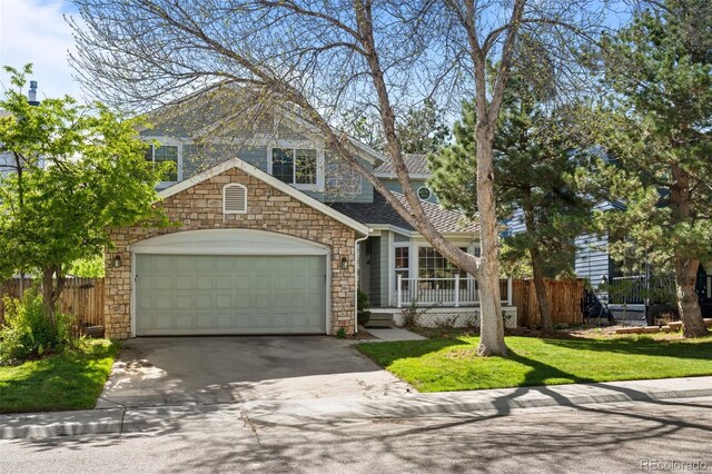 10519 Winterflower Way, Parker, CO 80134 - shingle-style home with stone siding, driveway, fence, and a garage