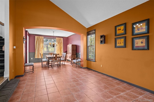 10519 Winterflower Way, Parker, CO 80134 - dining area featuring a chandelier, stairway, baseboards, arched walkways, and vaulted ceiling