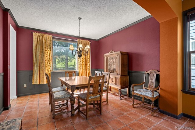 10519 Winterflower Way, Parker, CO 80134 - dining area featuring a textured ceiling, tile patterned flooring, ornamental molding, and a notable chandelier