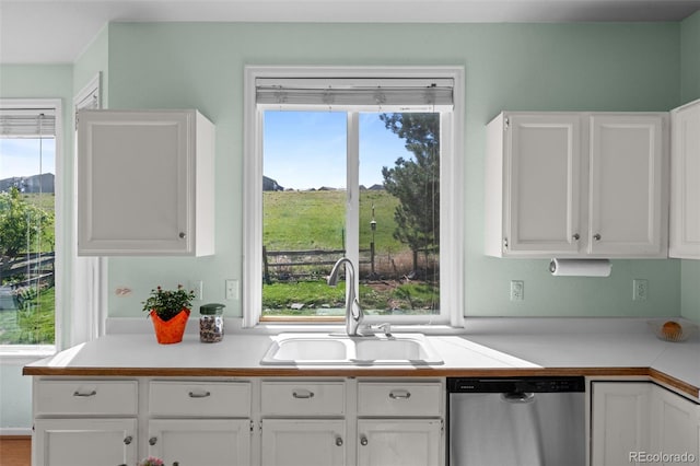 10519 Winterflower Way, Parker, CO 80134 - kitchen with white cabinetry, light countertops, a sink, and dishwasher