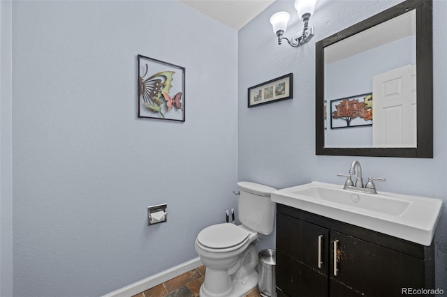 10519 Winterflower Way, Parker, CO 80134 - half bath featuring stone tile floors, toilet, baseboards, and vanity
