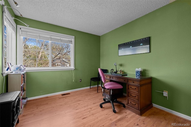10519 Winterflower Way, Parker, CO 80134 - home office with baseboards, light wood-style flooring, visible vents, and a textured ceiling