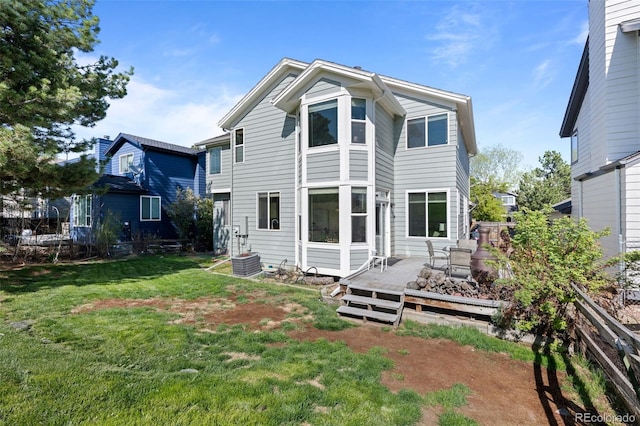 10519 Winterflower Way, Parker, CO 80134 - rear view of house featuring central AC unit, a deck, a lawn, and fence