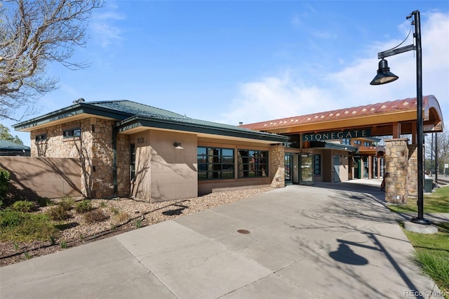 10519 Winterflower Way, Parker, CO 80134 - view of front of home featuring stone siding, driveway, and metal roof