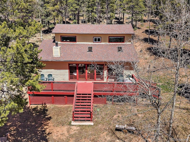 10852 Conifer Mountain Rd, Conifer, CO 80433 - rear view of house with stairway, a deck, roof with shingles, and view of scattered trees
