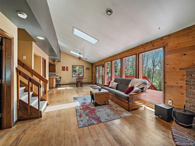10852 Conifer Mountain Rd, Conifer, CO 80433 - living area featuring healthy amount of natural light, vaulted ceiling, light wood-type flooring, and a skylight