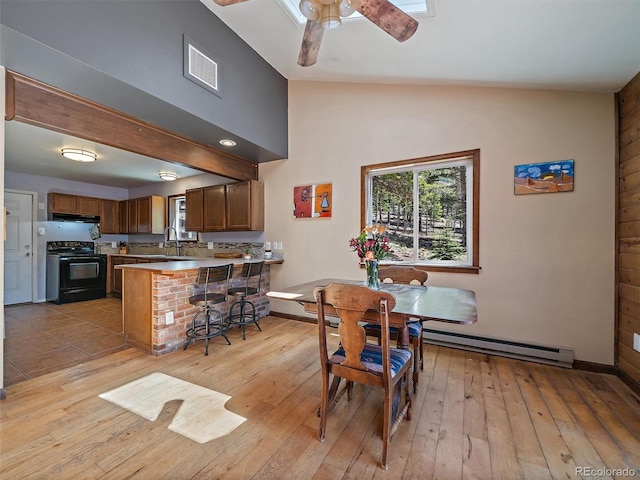10852 Conifer Mountain Rd, Conifer, CO 80433 - dining area with a baseboard radiator, light wood-type flooring, a ceiling fan, vaulted ceiling, and baseboards
