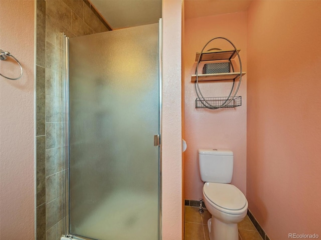 10852 Conifer Mountain Rd, Conifer, CO 80433 - bathroom with a shower stall, toilet, and tile patterned floors