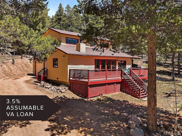 10852 Conifer Mountain Rd, Conifer, CO 80433 - back of house featuring a deck, stairway, and a shingled roof