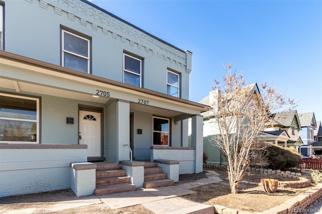 townhome / multi-family property with a porch