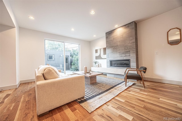 822 Fairfax St, Denver, CO 80220 - living area featuring light wood-style floors, a tiled fireplace, and recessed lighting