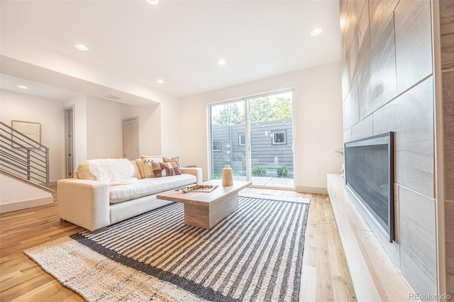 822 Fairfax St, Denver, CO 80220 - living room with light wood finished floors, recessed lighting, a premium fireplace, and stairs