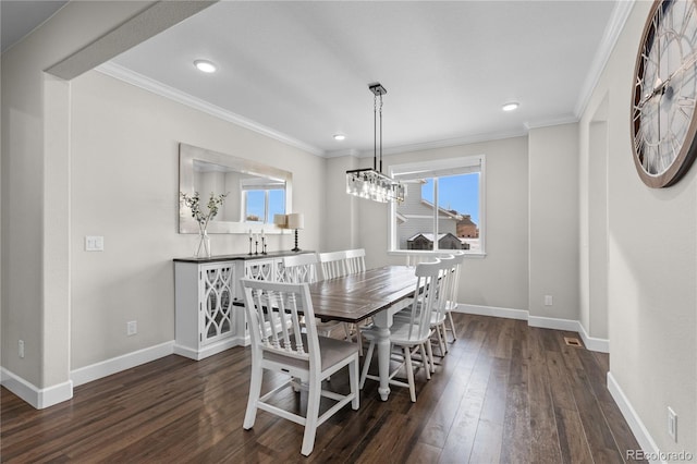 dining area with crown molding and dark hardwood / wood-style flooring