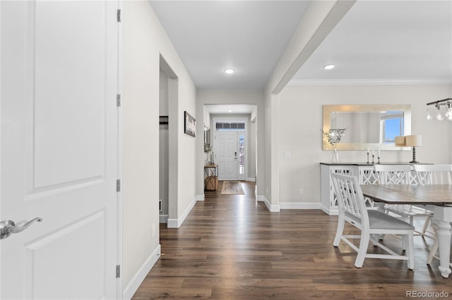 corridor featuring ornamental molding and dark hardwood / wood-style floors