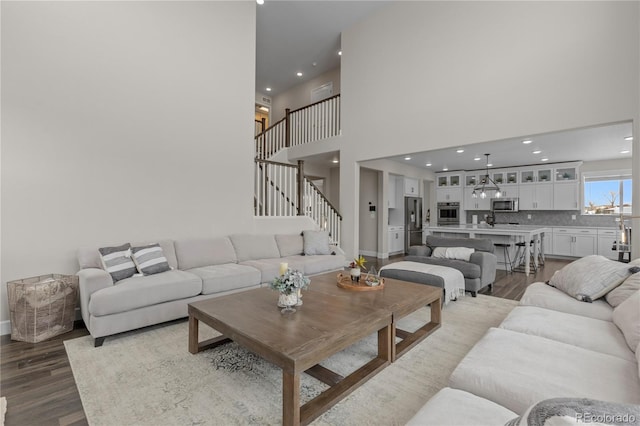 living room featuring hardwood / wood-style flooring and a high ceiling