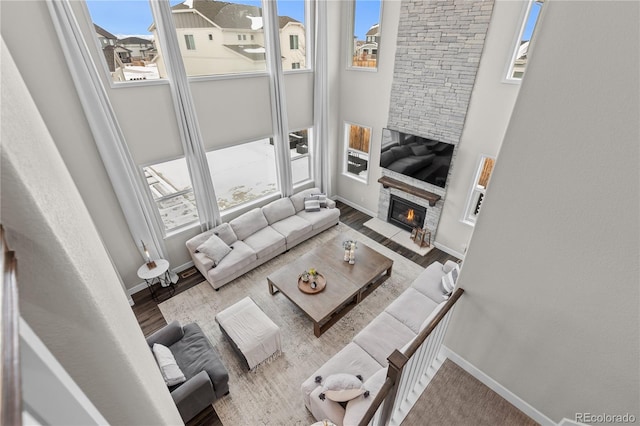 living room featuring hardwood / wood-style flooring and a stone fireplace