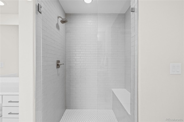 bathroom with a tile shower