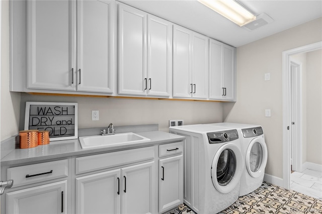 washroom featuring sink, independent washer and dryer, cabinets, and light tile patterned flooring